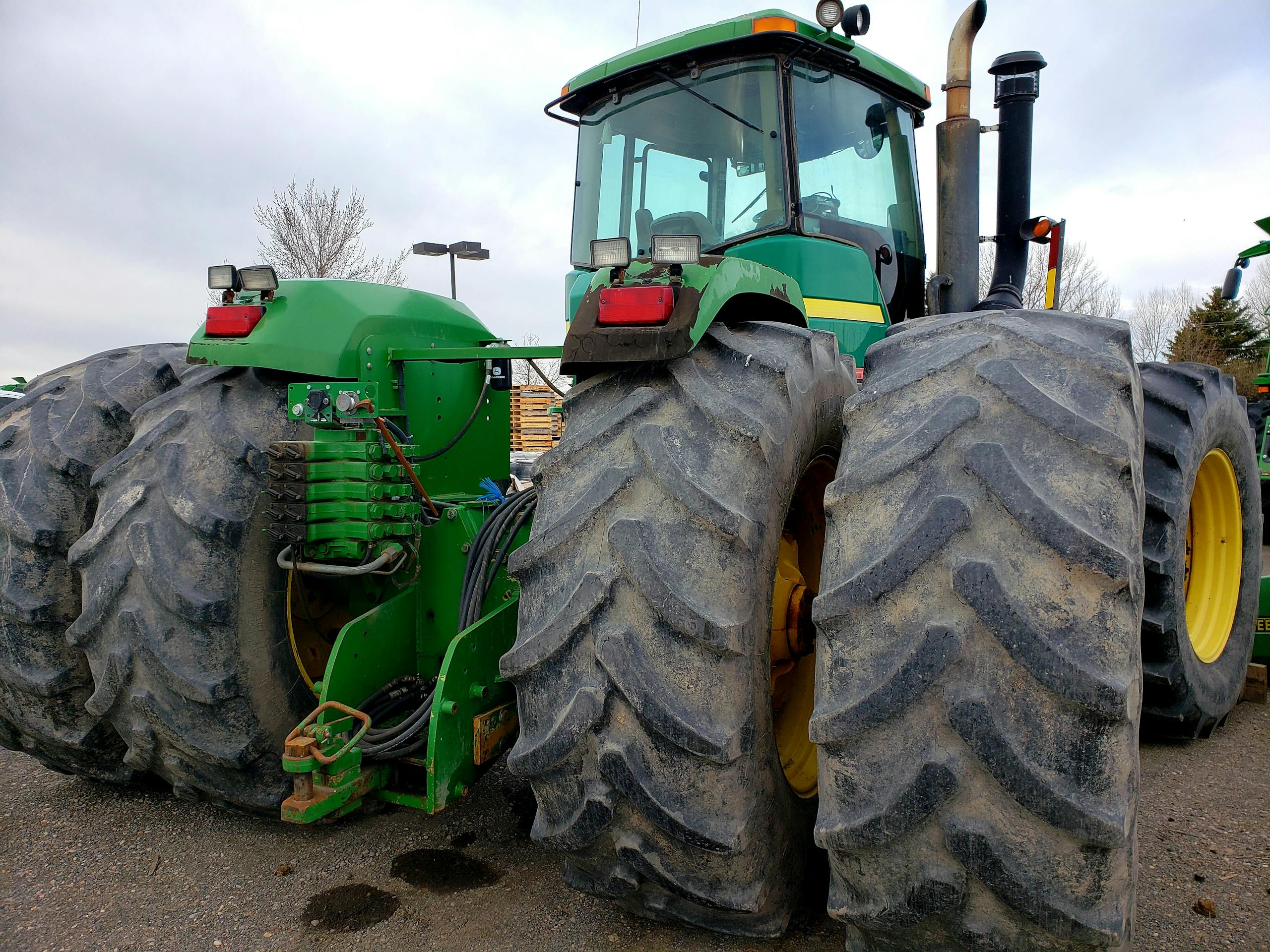 Massive green tractor with large tires suited for heavy-duty agricultural work.